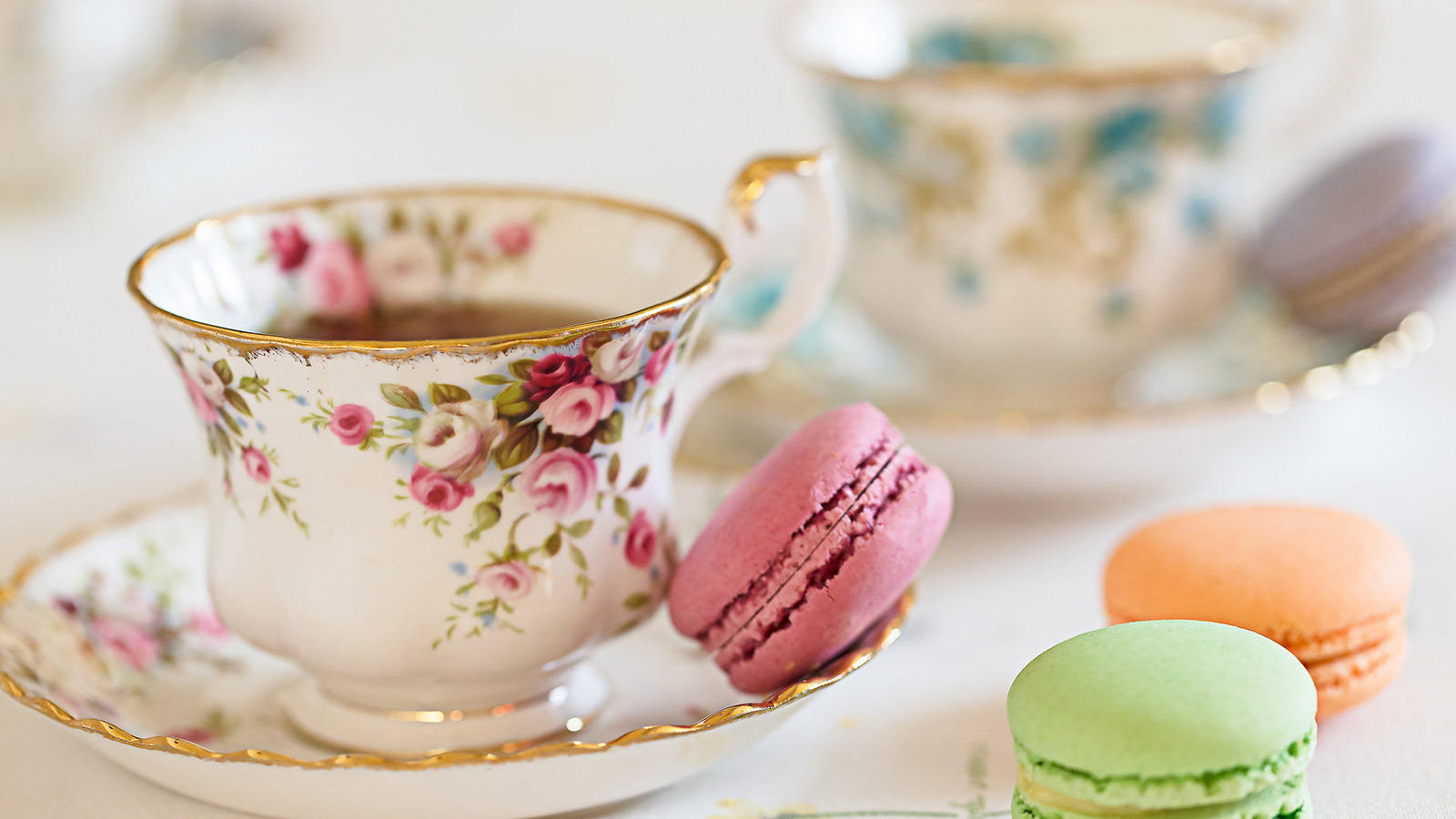 Pretty tea cup and saucer with macaroons