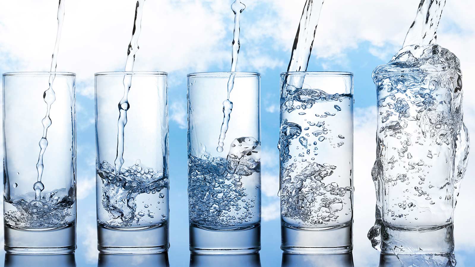 five glasses of water filling with cloud background
