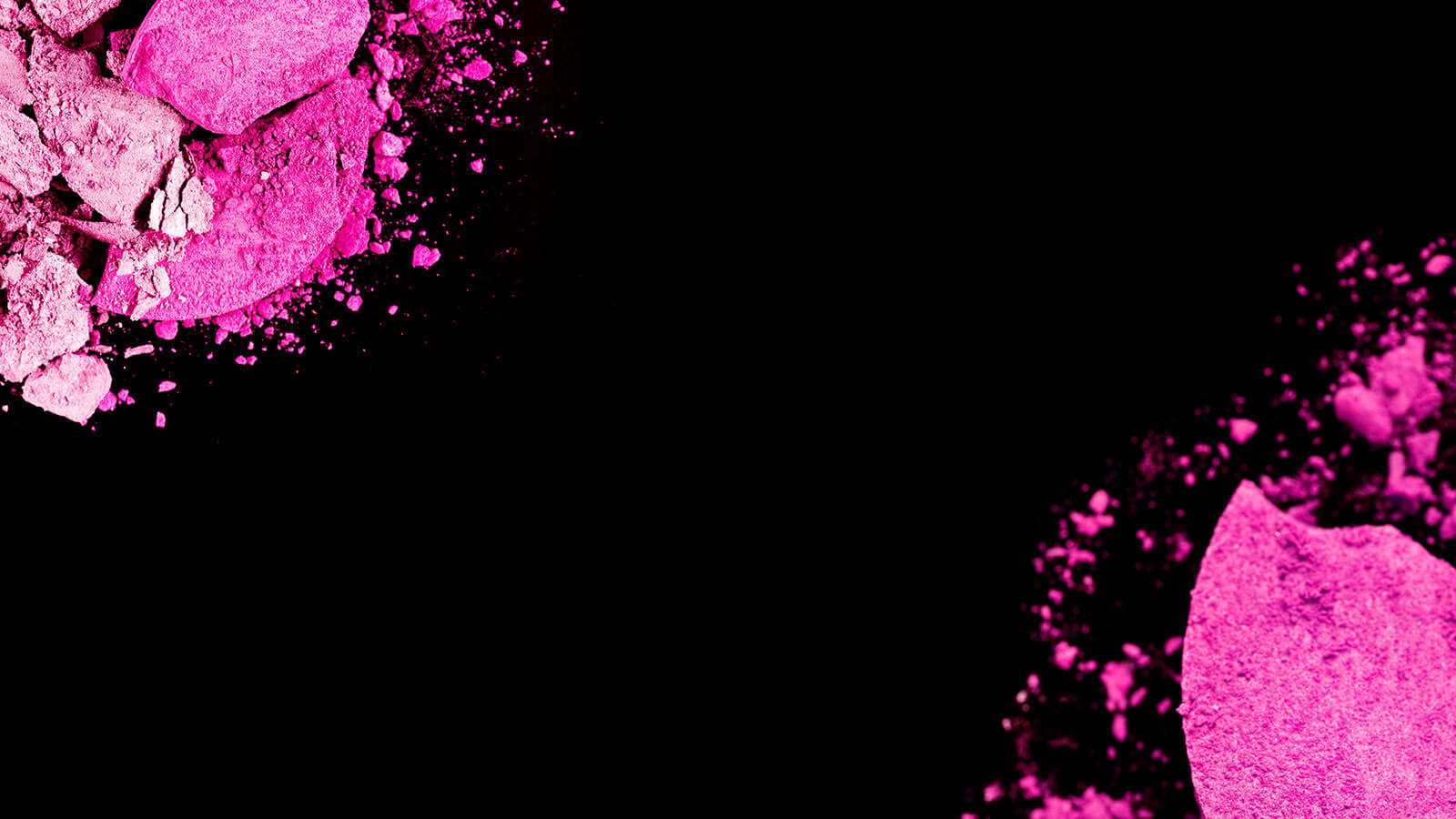 crushed pink makeup on black background