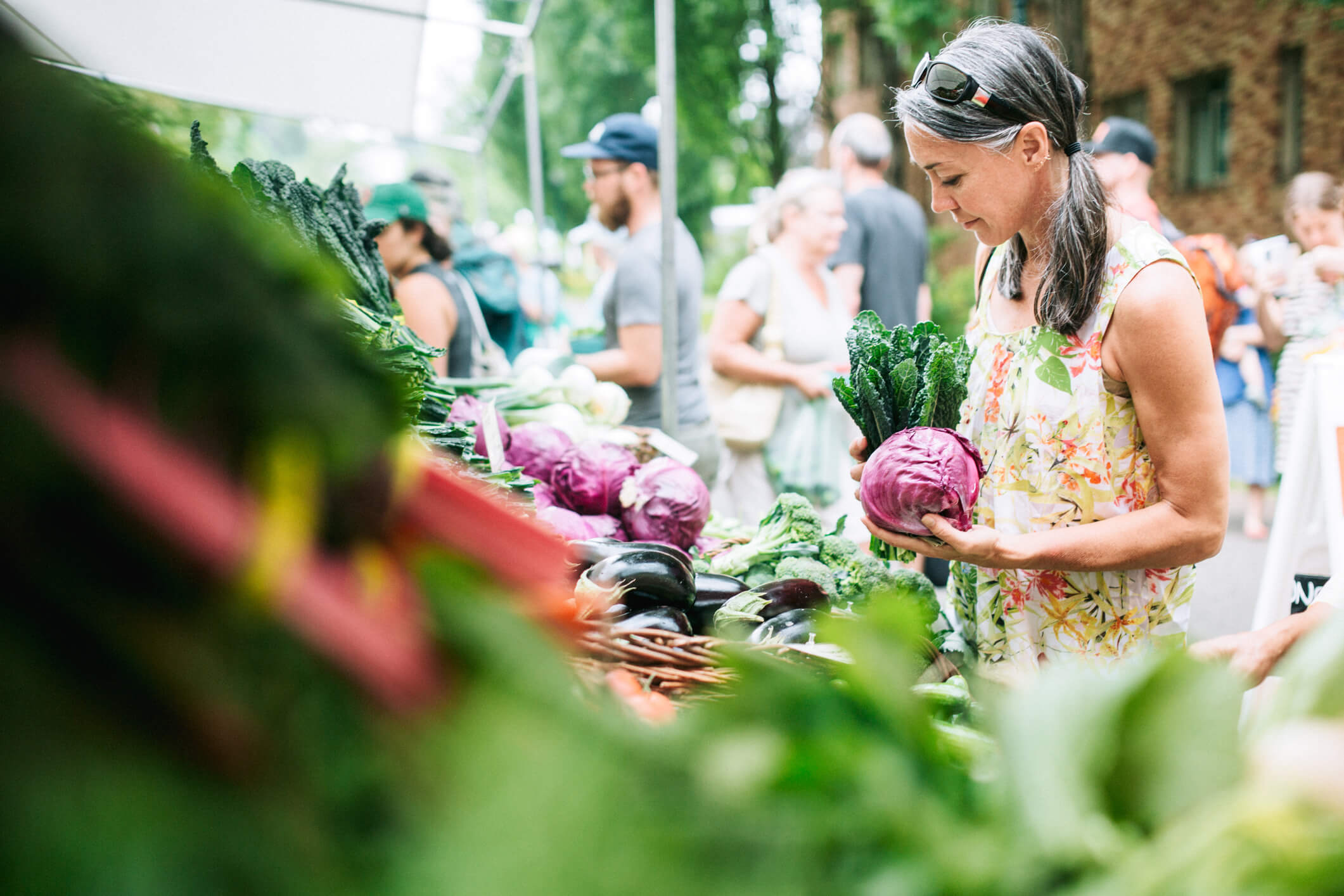 woman looking at food at the farmer's market