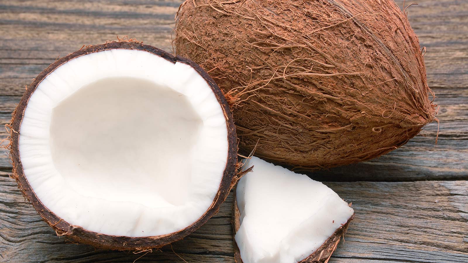 Coconut broken on a wooden board